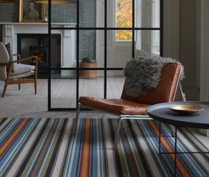 orange, grey, blue and brown stripped rug by crucial trading